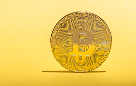 Bitcoin on yellow backgroundの写真素材