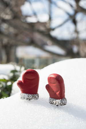 Christmas boots and gloves on the snowの写真素材