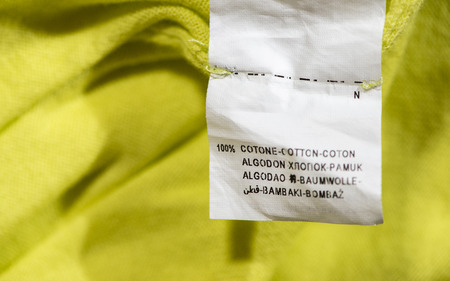 Label for cotton composition. Close up label on green blouse.の写真素材