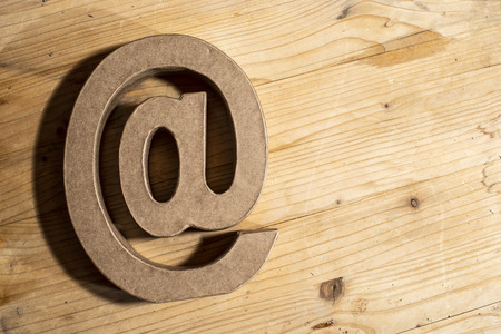Email symbol made of paper on wooden backgroundの写真素材