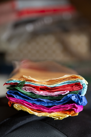 Various colours. Multicolored stacked papers. Close up shot.の写真素材