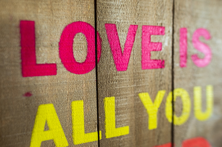 Love is all you need text on pink wall in a room. Natural day light from window. Love need concept.の写真素材