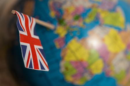 British flag on the world map. UK flag pricked on the globe points to the United Kingdom.の写真素材