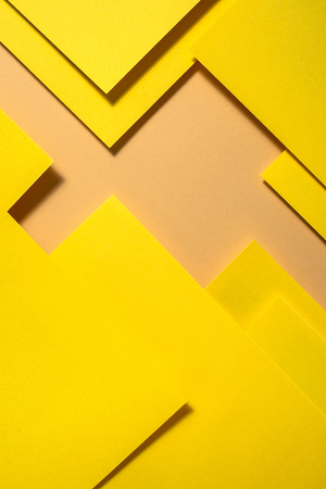 Yellow paper material design. Geometric unicolour shapes. Wallpaper design background.の写真素材
