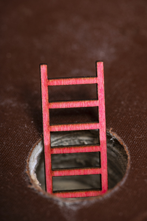 Stacked books and small ladder appear from inside the book. Abstract illustration concept for knowledge and education.の写真素材