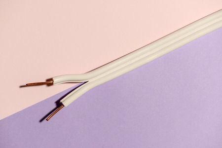 Electrical cable on pink pastel background. Spread out copper wires. Minimalist electrical...