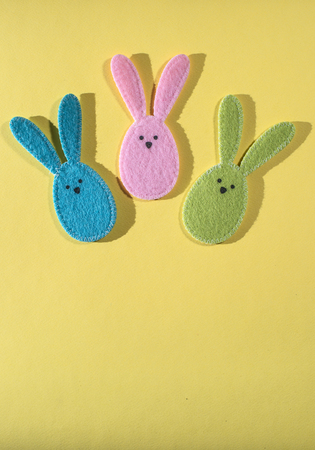 Easter bunnies on bright yellow background.の写真素材