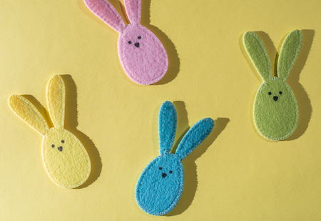 Easter bunnies on bright yellow background.の写真素材