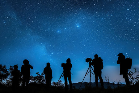 Silhouettes of people stargazing against a night sky.の素材
