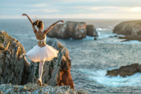 A ballet dancer practicing on a rocky cliff overlooking the ocean.の素材