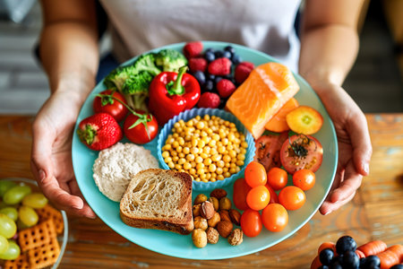 Diets: A person reviewing a colorful plate chart, surrounded by fruits, vegetables, grains, and proteins, planning a balanced meal.の素材