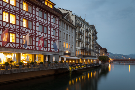 Tranquil night scene with reflections of the lights in the calm water of Lake Lucerne of the historic timbered buildings on Lucerne waterfront, Switzerland in a scenic viewのeditorial素材