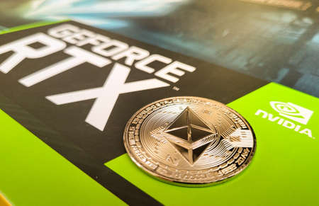 Penang, Malaysia - January 9, 2022: Golden Ethereum token coin on a Nvidia GPU. Ethereum Mining concepts.のeditorial素材