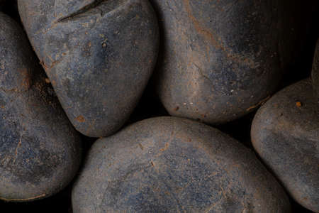 Black round cobble stone texture for wallpaper and background. Abstract background. Texture background. Macro photography. Close up.の写真素材