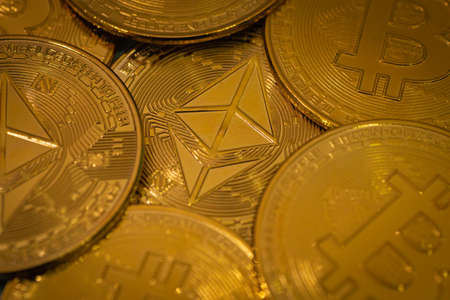 Golden Ethereum tokens with Ethereum Symbol among Bitcoin. Digital currency. Cryptocurrencyの写真素材