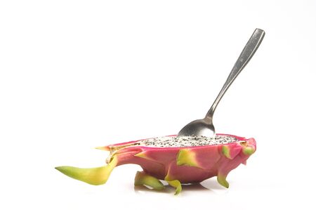 Pitahaya halves on block with spoon isolated one a white backgroundの写真素材