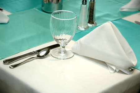 Corner of table with formal setting in restaurant.の写真素材
