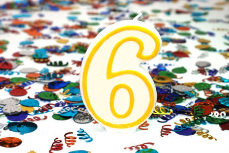 Number 6 celebration candle with confetti.の写真素材