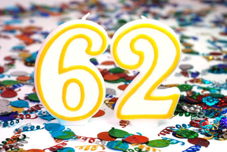Number 62 celebration candle with confetti.の写真素材