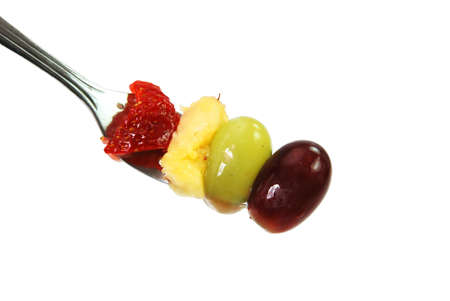 Strawberry, honeydew melon, and grapes on fork isolated on white background with clipping path.の写真素材