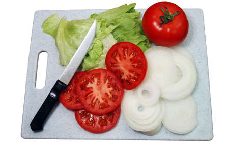 Tomato, lettuce, onions and knife on cutting board.  Isolated on white background with clipping path.の写真素材