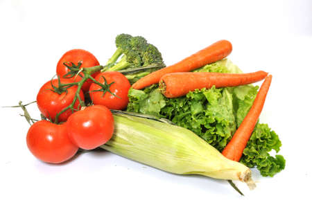 Green leafy lettuce, tomatoes, broccoli, carrots, and corn isolated on white background.の写真素材