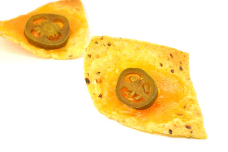 Two nachos with focus on one.  Isolated on white background.の写真素材