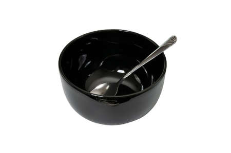 Empty black bowl and spoon isolated on white background with clipping path.の写真素材