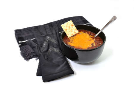 Bowl of chili with melted cheese and spoon and gloves and scarf.  Isolated on white background.の写真素材
