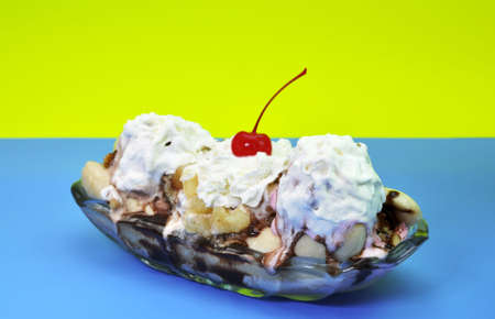 Banana split isolated on blue and yellow background.の写真素材