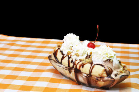 Banana split on table with black background.の写真素材