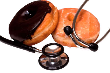 Unhealthy eating showing glazed and chocolate donuts and stethoscope.の写真素材