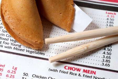 Chinese restaurant menu with chopsticks and fortune cookie.の写真素材
