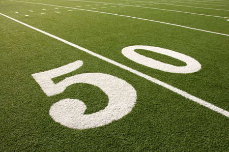 Closeup of 50 yard line on American football field.