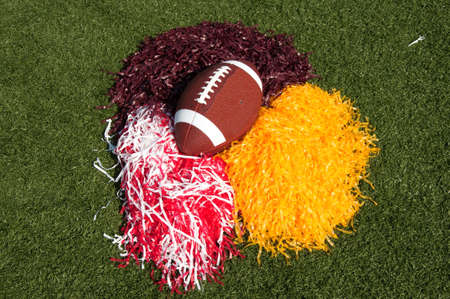 American football and pom poms on field.の写真素材