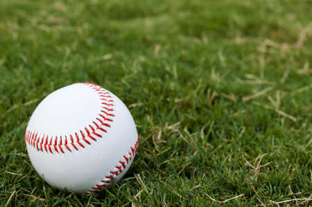 Closeup of baseball on grass with copy space.の写真素材