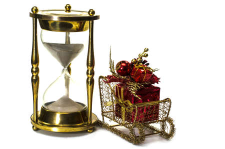 Christmas gift on sleigh and hourglass on white background   Concept showing time running out for Christmas shopping の写真素材
