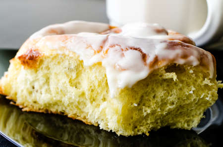 Closeup of cinnamon bun and coffee.の写真素材