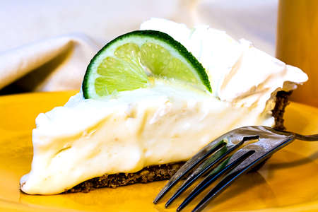 Key lime pie closeup with fork on plate.の写真素材