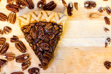 Pecan pie slice and pecans with copy space.の写真素材