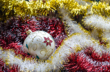Beautiful Christmas toy with purple and yellow garlands closeup.の写真素材