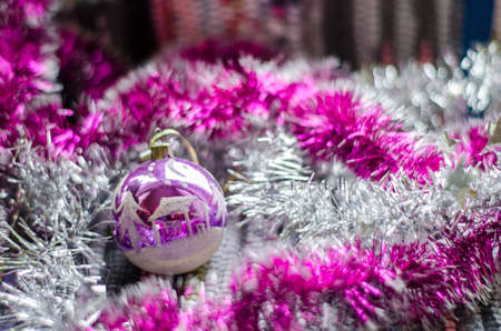 Beautiful Christmas white-purple toy with purple garland closeup.の写真素材