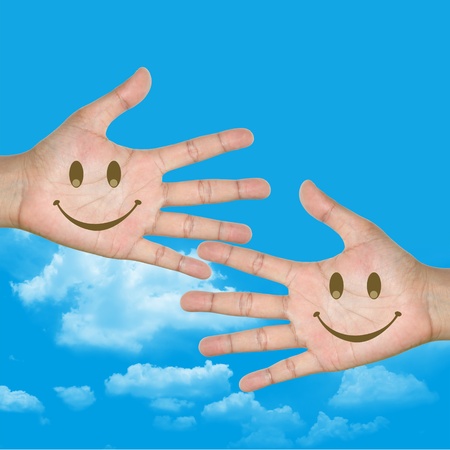 Smile Face in Hand With Blue Sky Backgroundの写真素材