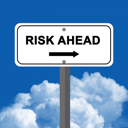Risk Ahead Street Sign Stand Against A Blue Sky Backgroundの写真素材