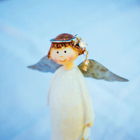 Angel figurine with nice gold earring. Blueの写真素材