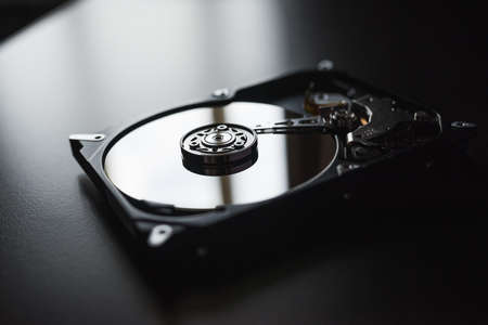 Opened hard drive from the computer (hdd) with mirror effects. Part of computer (pc, laptop)の写真素材