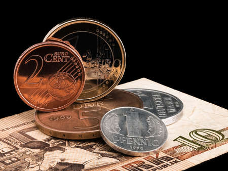 Coins of GDR  DDR  and the European union on a black background 