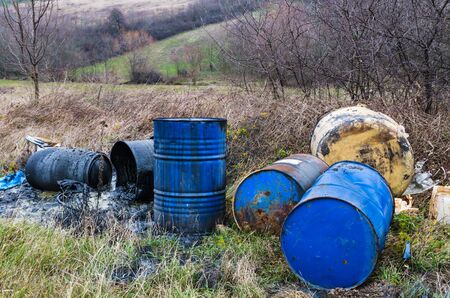 Barrels of toxic waste in nature, pollution of the environment.