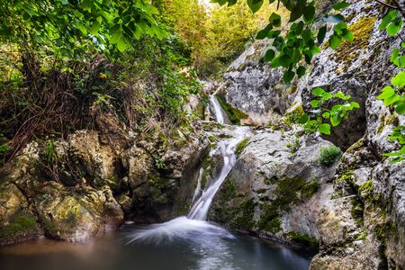 Small mountain creek waterfall cascading down the rocks in the village Ostrovica, Nature parkの写真素材