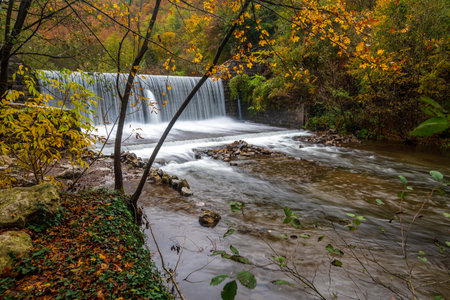River weir witch waterfall on Jablanica river near Valjevo city in Serbia on a rainy autumn day.の写真素材